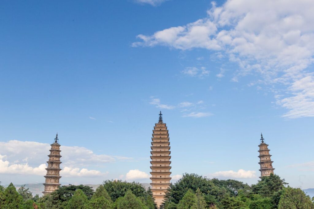 Dali Travel Guide: Embrace the Eternal Wind, Flower, Snow and Moon of Yunnan The iconic Three Pagodas at Chongsheng Temple against a clear blue sky, Yunnan, China.